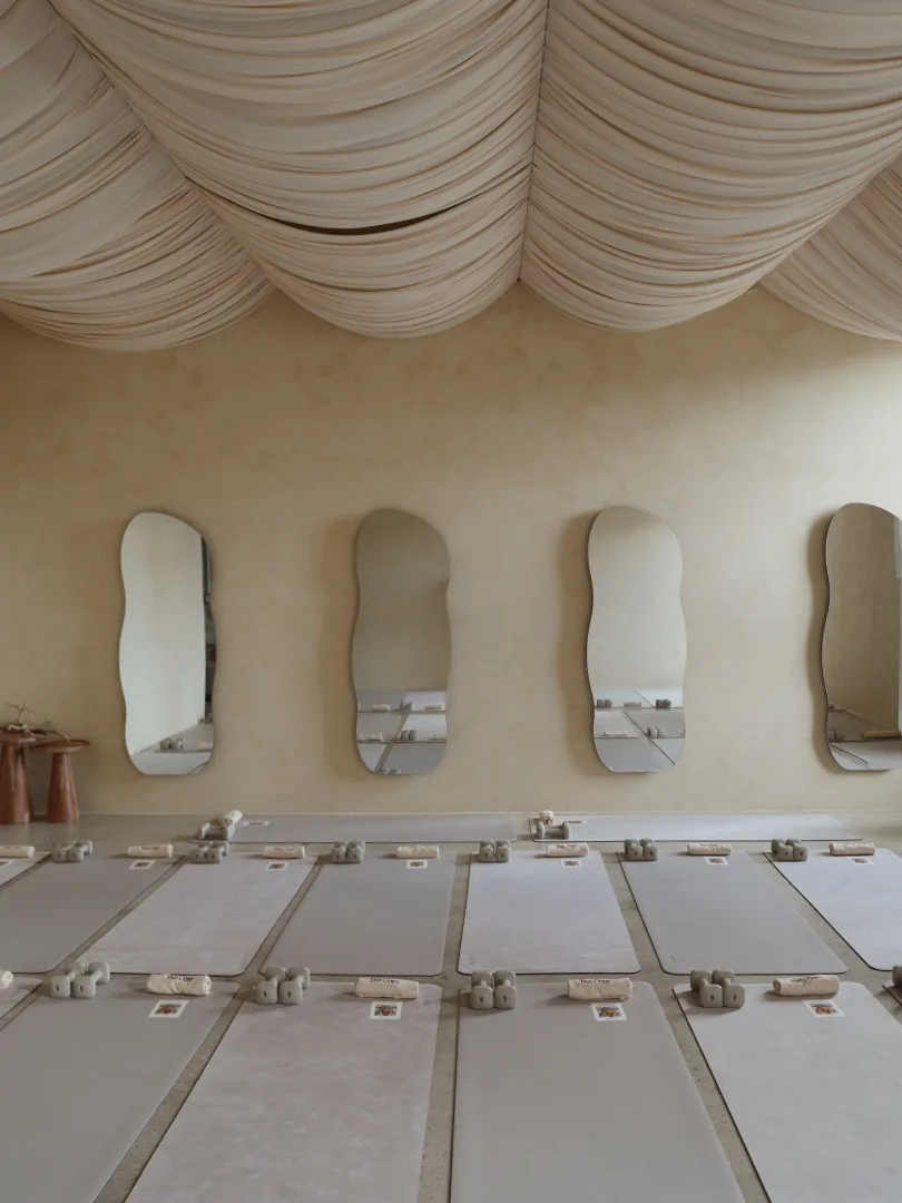 The Core studio in Miami Beach — draped ceiling, sculptural mirrors and mats set up for class